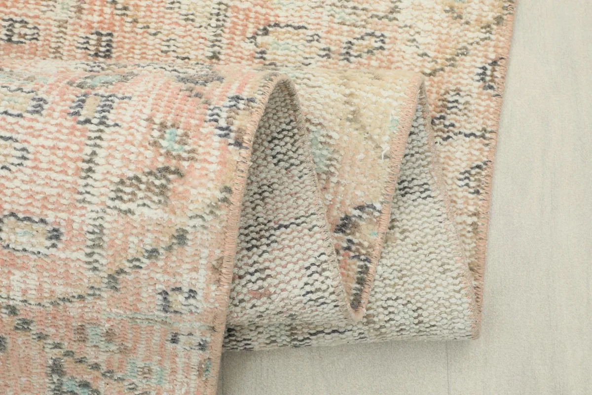 Close-up of the folded rug, revealing the texture and thickness from the side