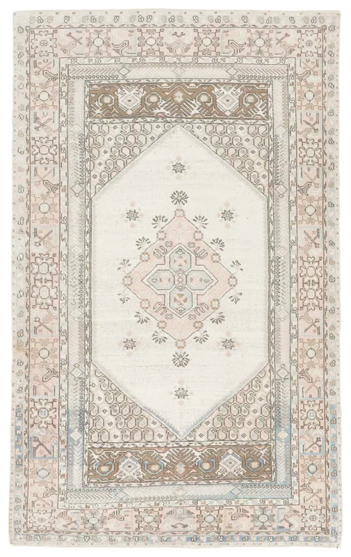 Full top view of the 5x8 ivory, rose, and blue vintage Anatolian rug on a white background.