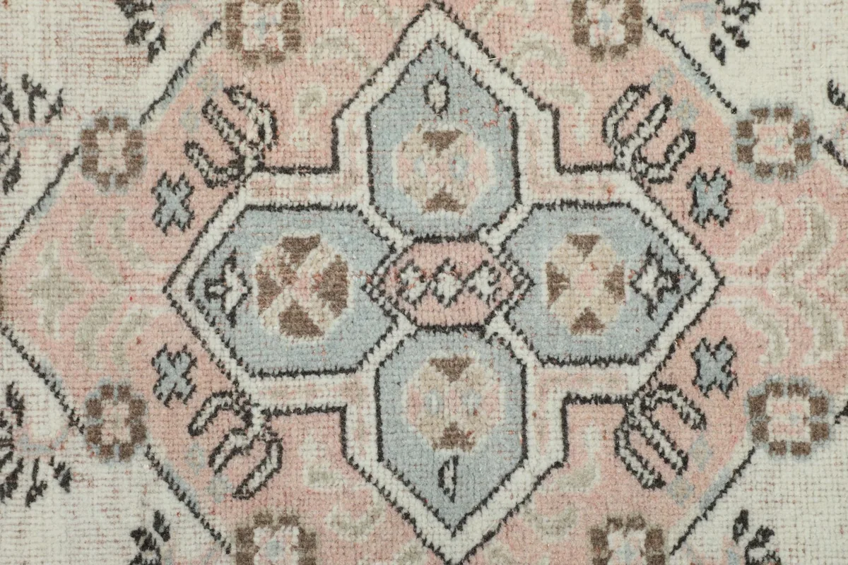 Detailed shot of the central medallion, highlighting its intricate rose, blue, and brown motifs.