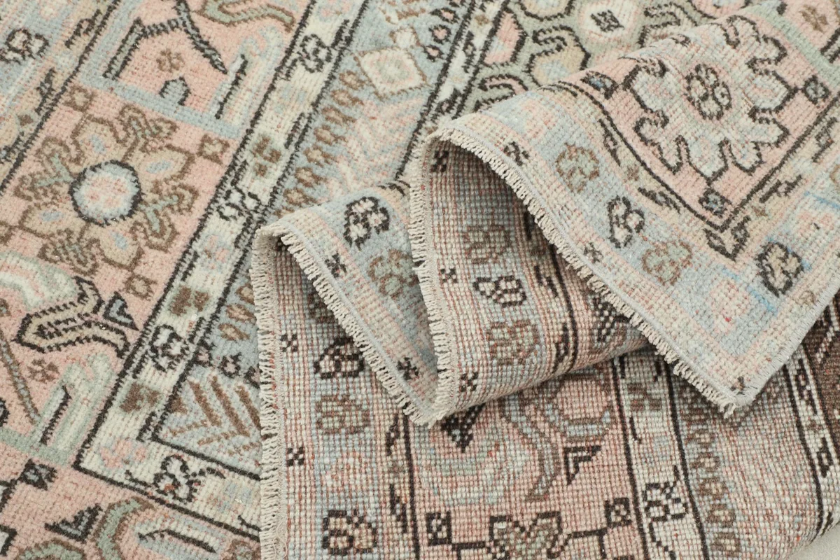 Rug folded to reveal the texture and the intricate patterns on the pile and the reverse.