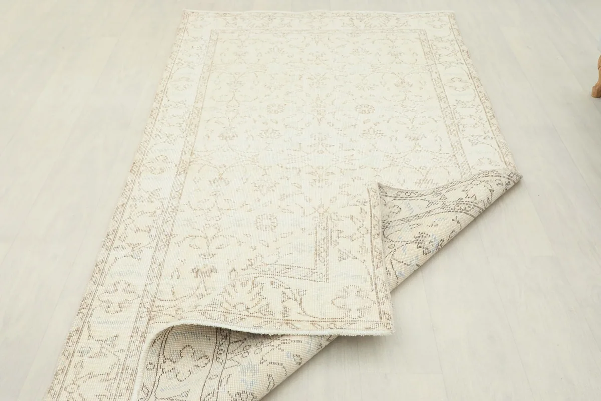 View of the vintage Anatolian rug partially folded, highlighting its flexibility and construction