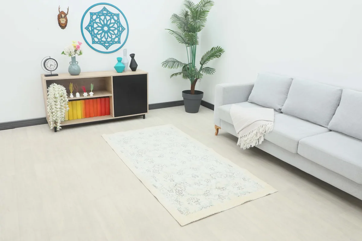 Ivory and gray vintage rug placed in a modern living room setting.