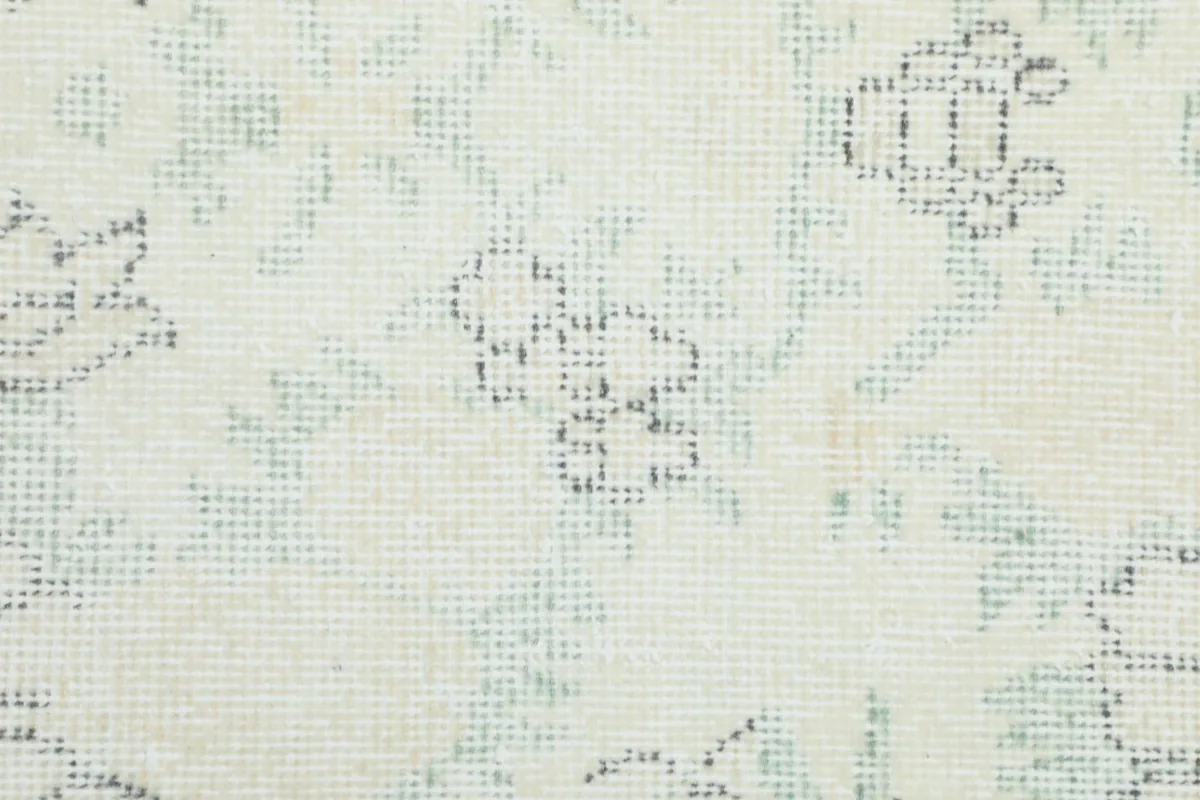 Detailed close-up of the low wool pile and the intricate knotting of the rug.