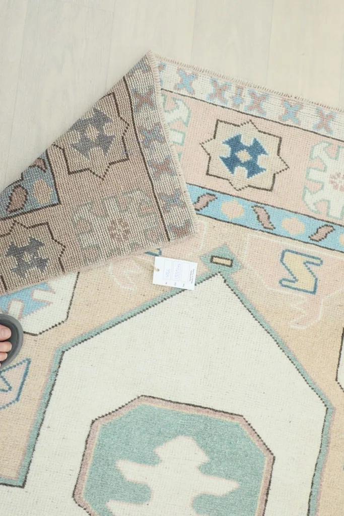 Close-up of the back of the rug, revealing the tight hand-knotted wool on cotton foundation