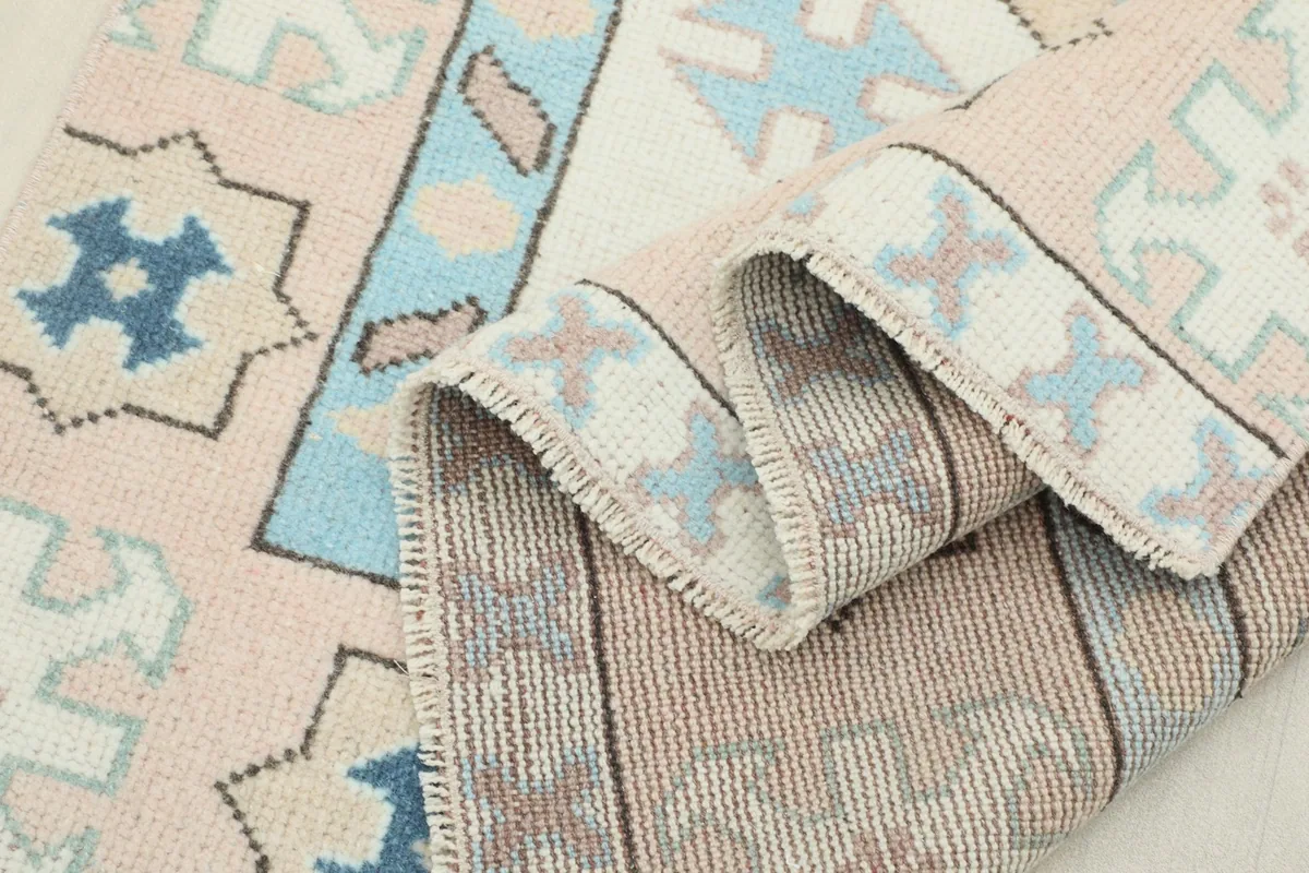 Another view of the rug folded, emphasizing the texture and intricate weave