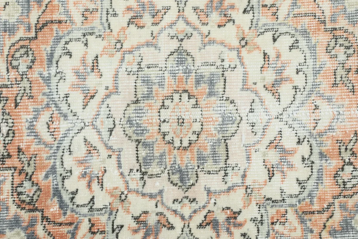Close-up of the intricate knotting and color variations within the rug's medallion