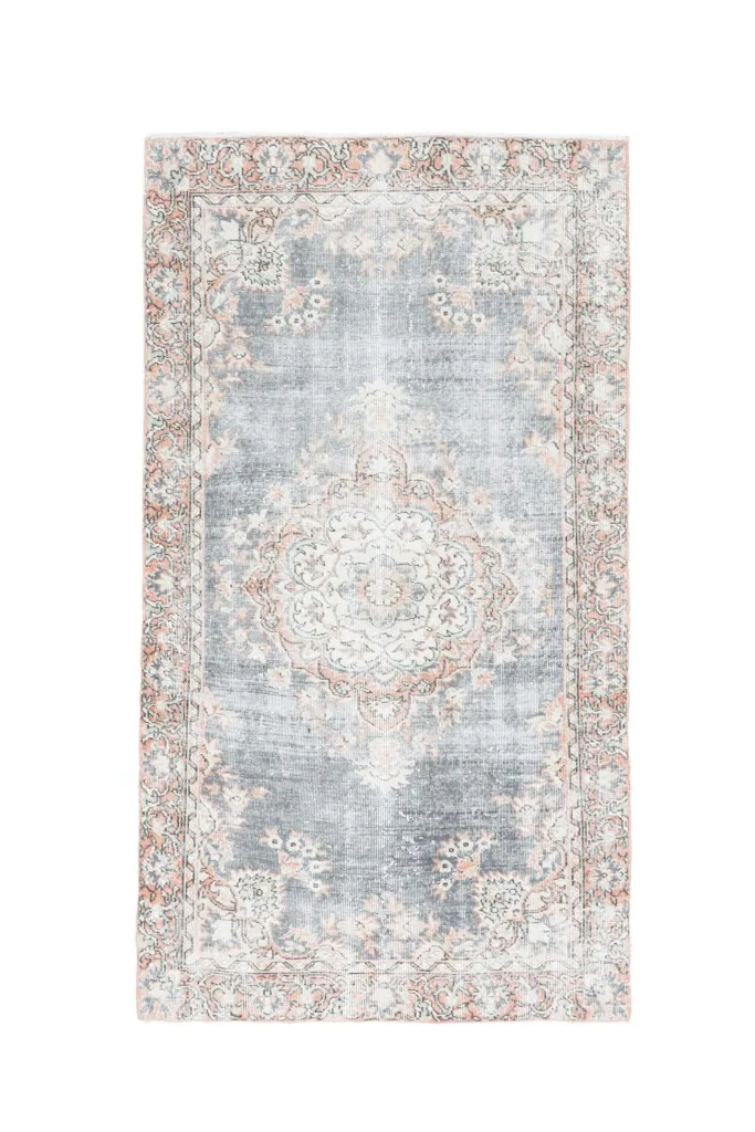 Full overhead view of the vintage gray and orange area rug