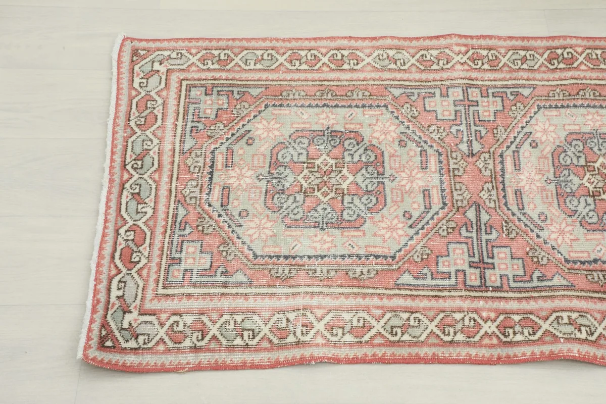 Corner view of the runner rug, highlighting the border design and color variations