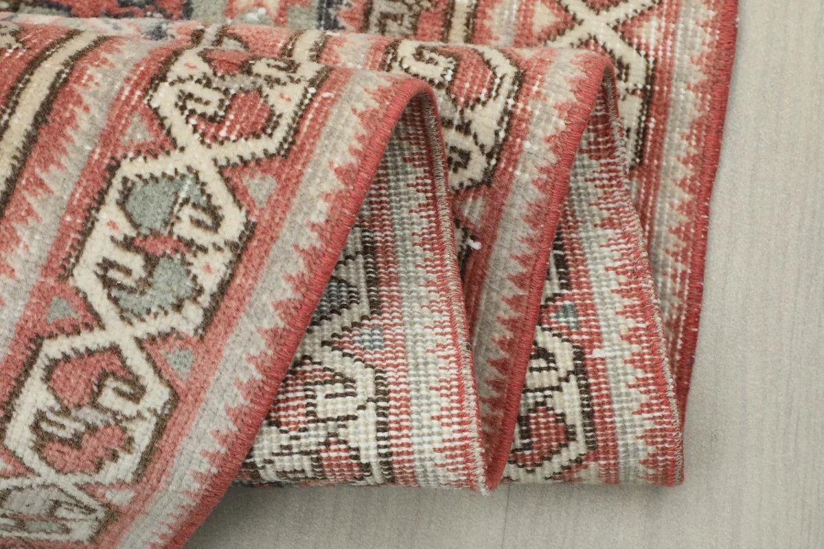 Multiple folds of the runner rug, displaying the density of the wool pile and backing