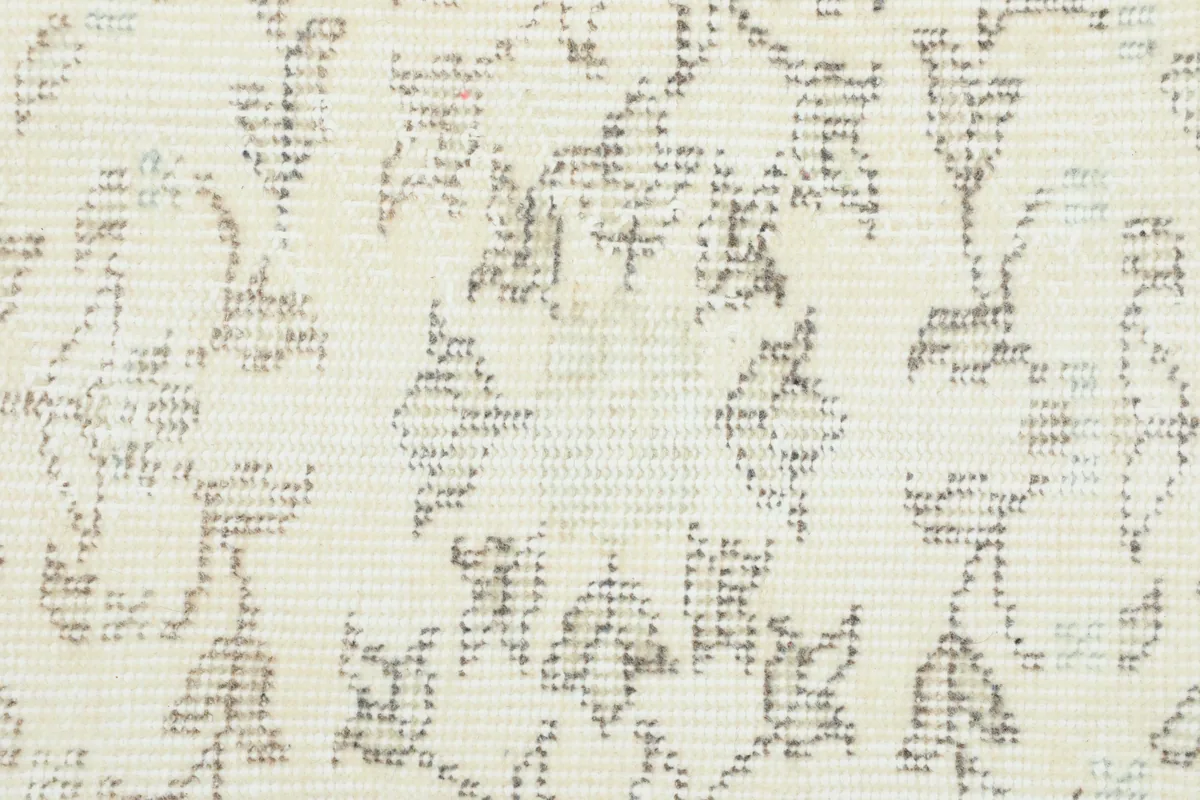 Close-up of the Cream Floral Anatolian Rug's pattern, highlighting the distressed texture and subtle color variations