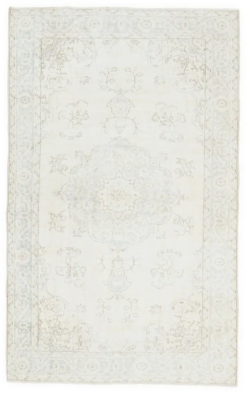Full top view of the 5'4" x 8'7" ivory and blue vintage Anatolian area rug with a central medallion.