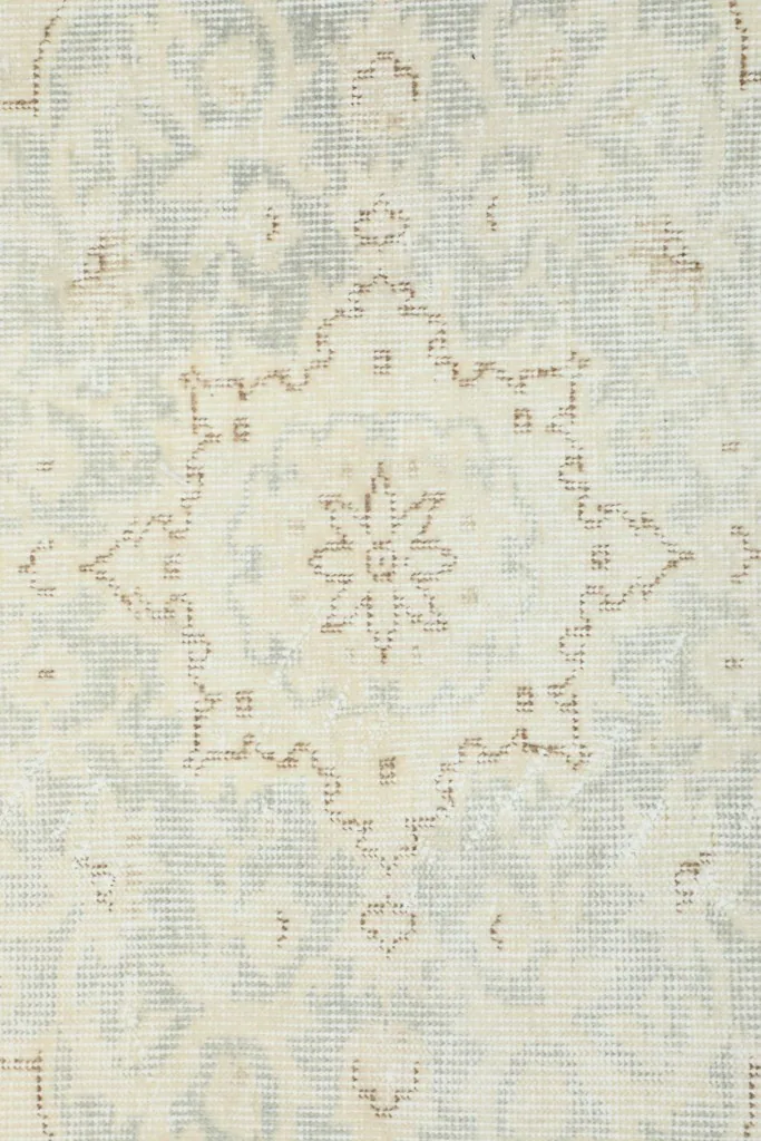 Close-up of a section of the medallion, highlighting the hand-knotted texture and color variation.