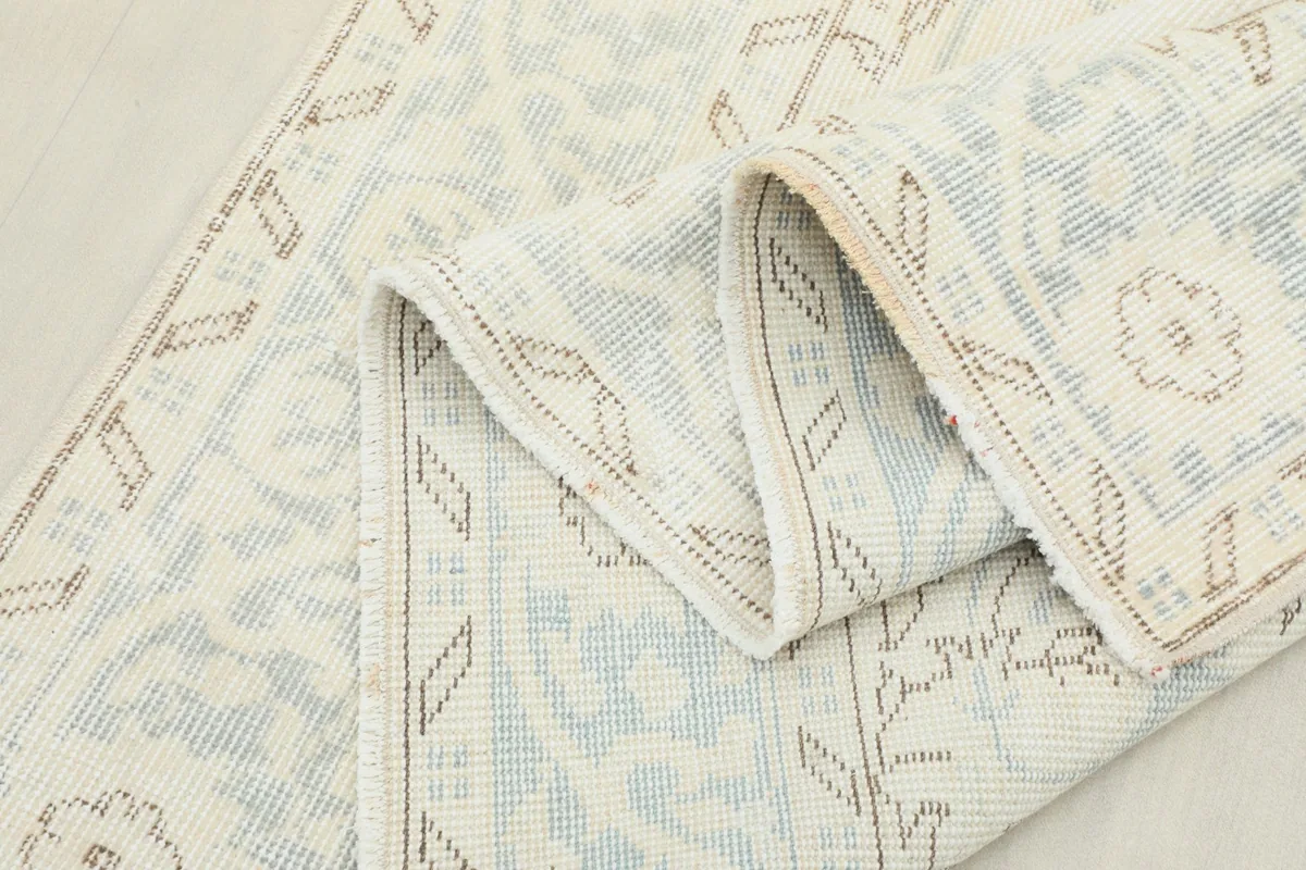 Rug folded to show the flexibility and quality of the hand-knotted wool pile.