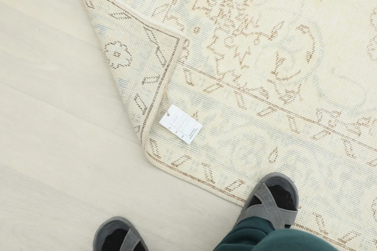 View of the rug with a size tag, showing the texture and overall appearance from a low angle.