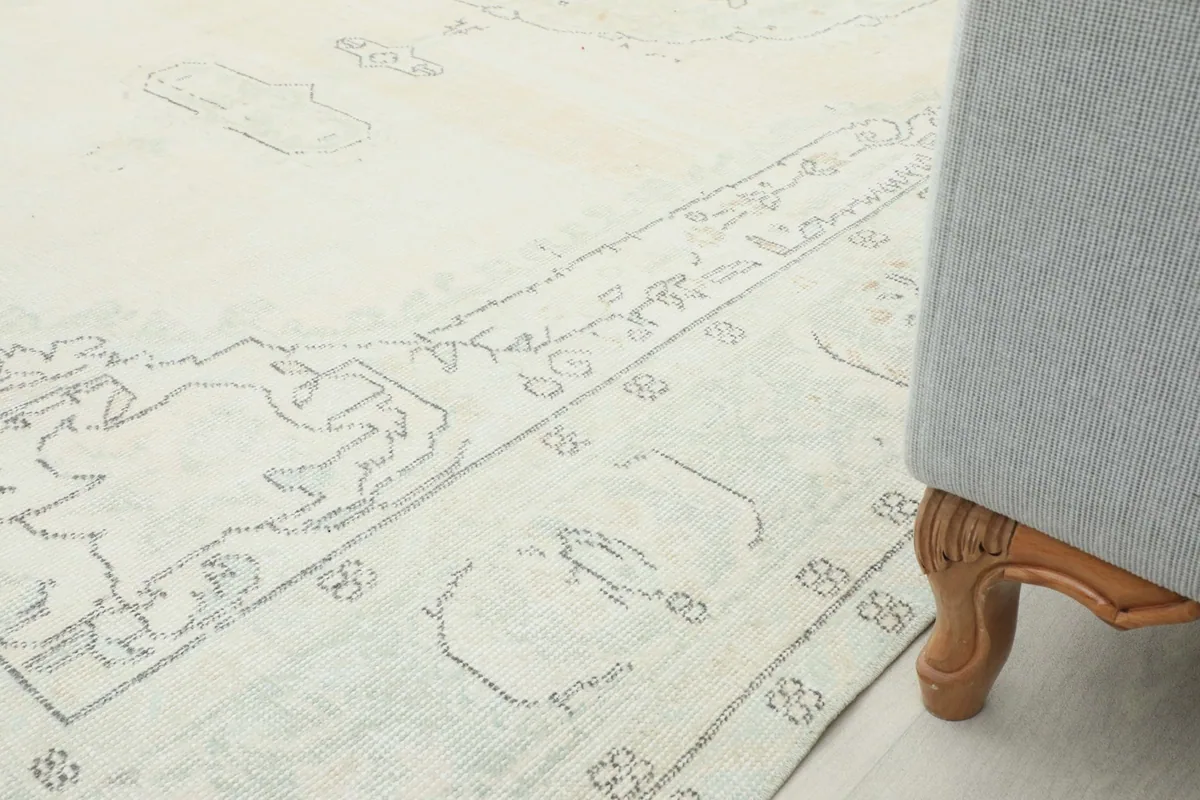 Side view of the rug next to a chair leg, illustrating its size and integration into a living space