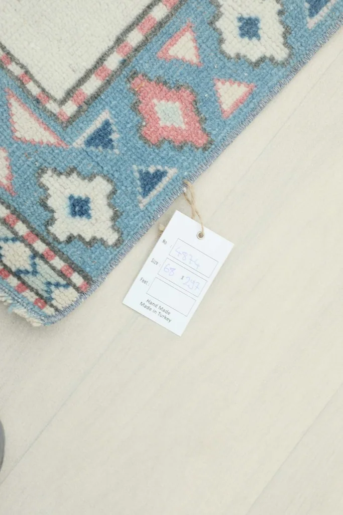 Corner of the rug with the product tag attached, showing the back and edge details