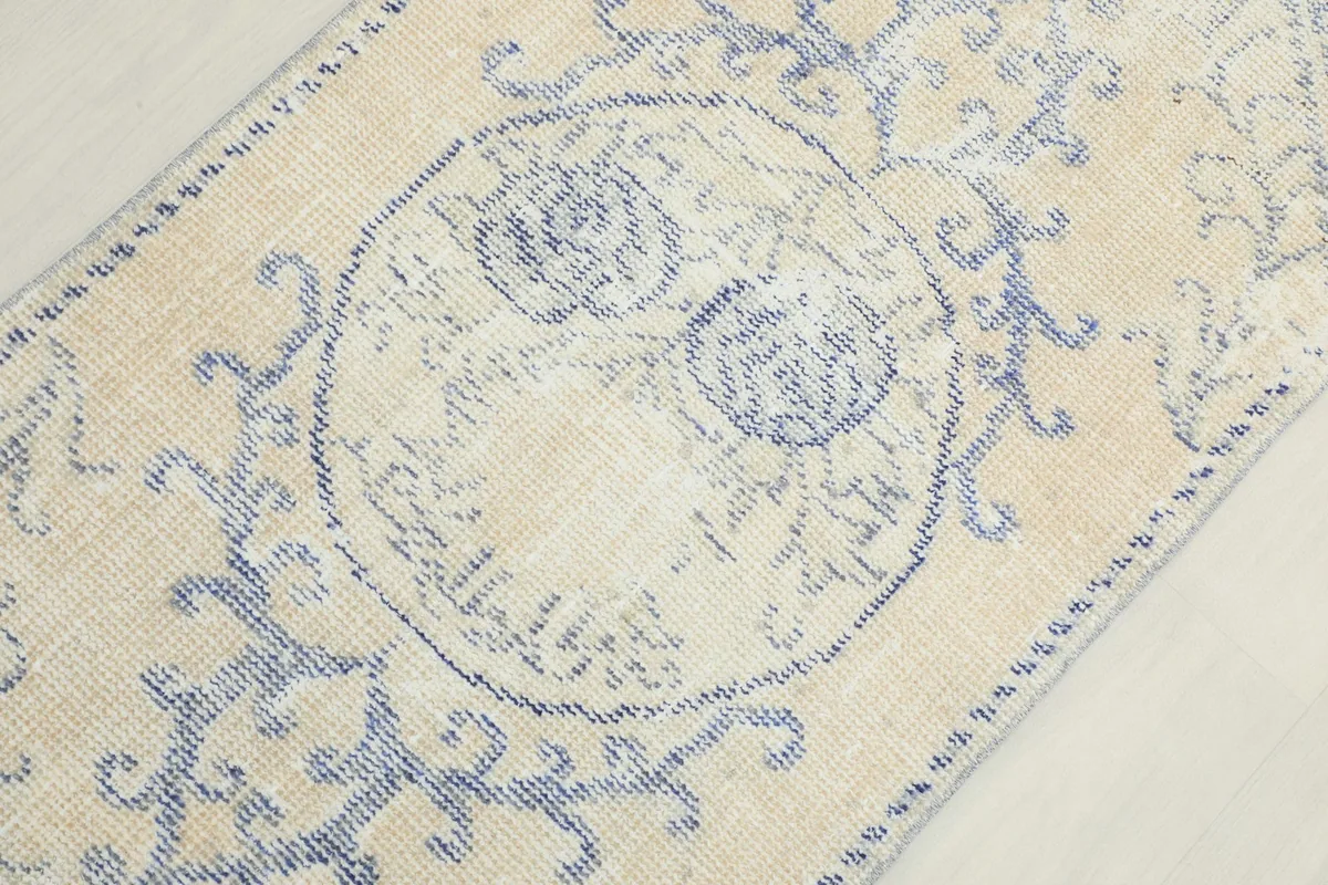 Detailed view of the central medallion design and surrounding motifs on the rug