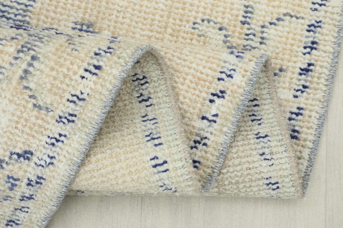 Close-up of the rug's edge, showing the natural fringe and construction