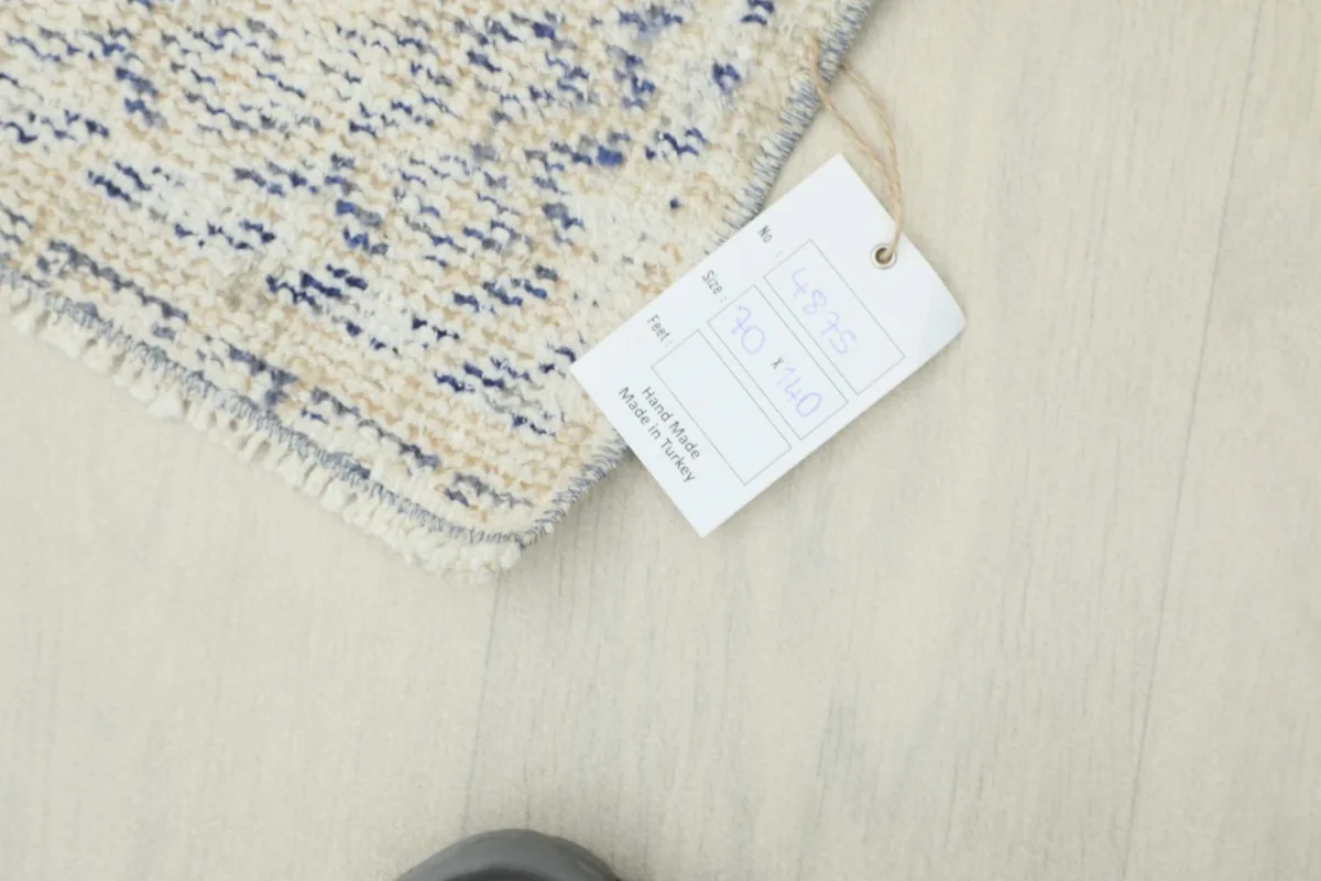 A tag attached to the rug, indicating it is handmade in Turkey