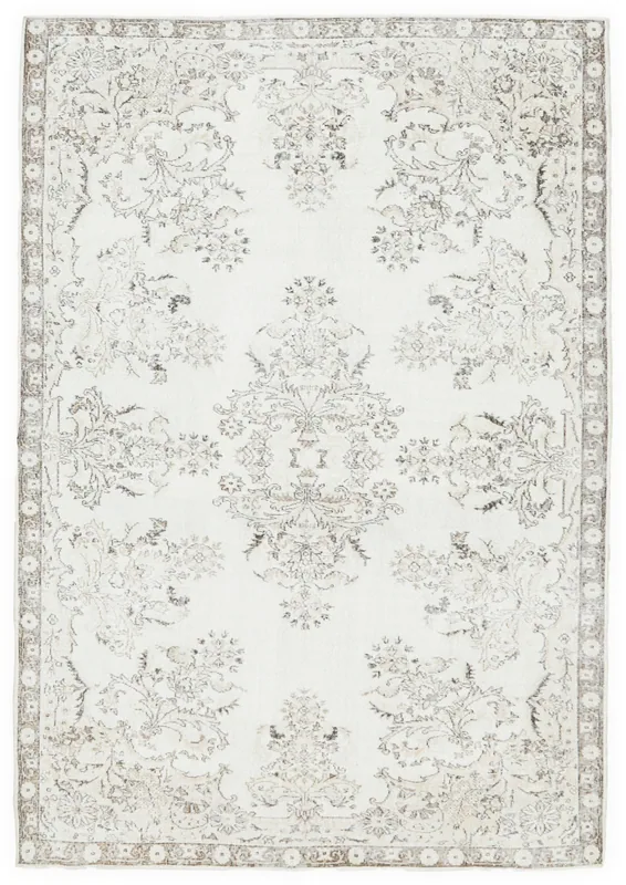 Full top view of the vintage ivory and brown floral Anatolian rug on a white background