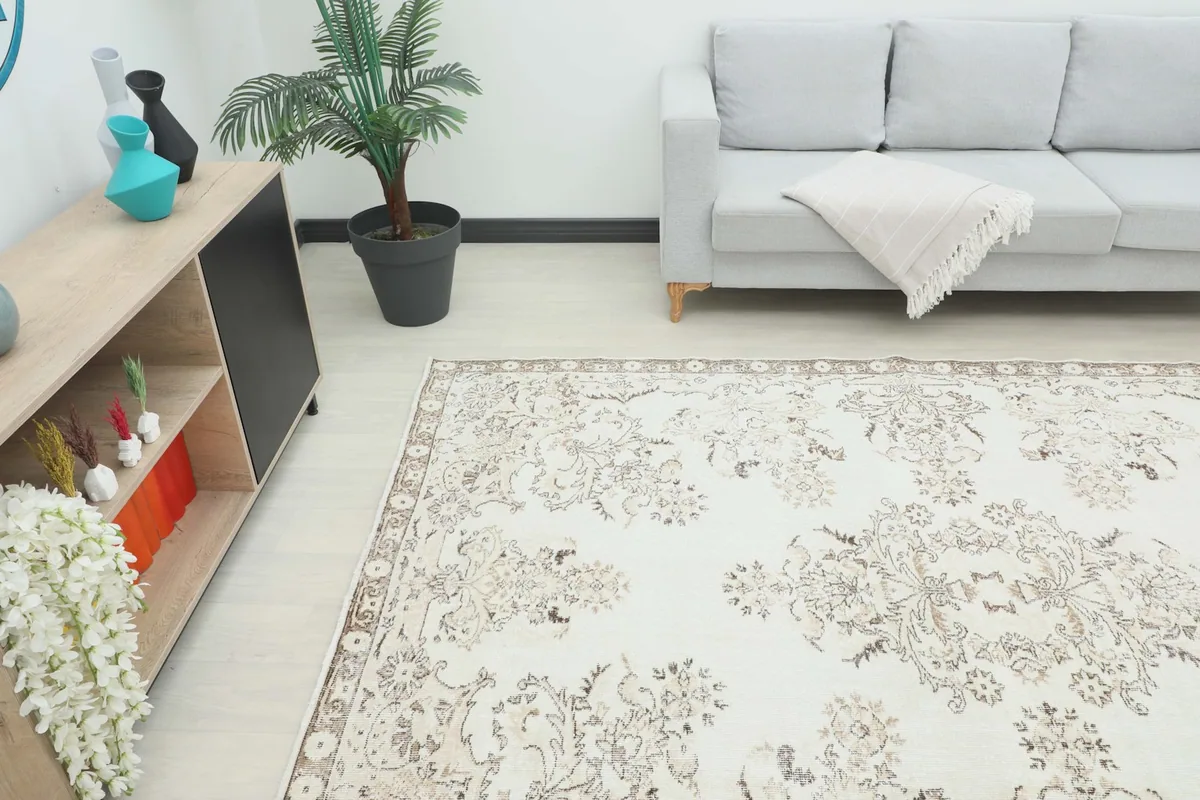 Overhead view of the ivory floral rug in a room with modern furniture and decor
