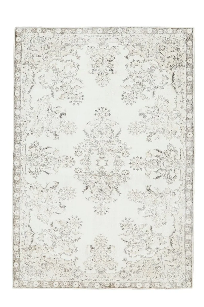 Full overhead view of the vintage ivory and brown floral Anatolian rug, showcasing its complete design
