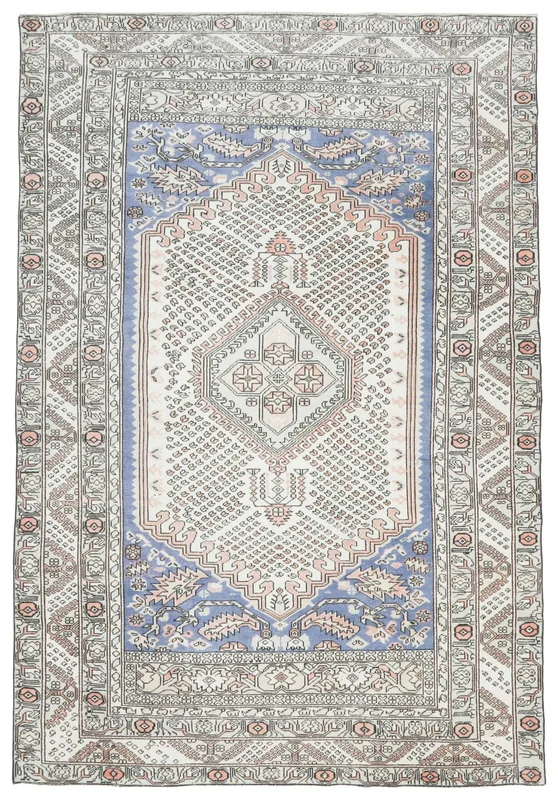 Full overhead view of the vintage Anatolian rug with an ivory field and blue medallion