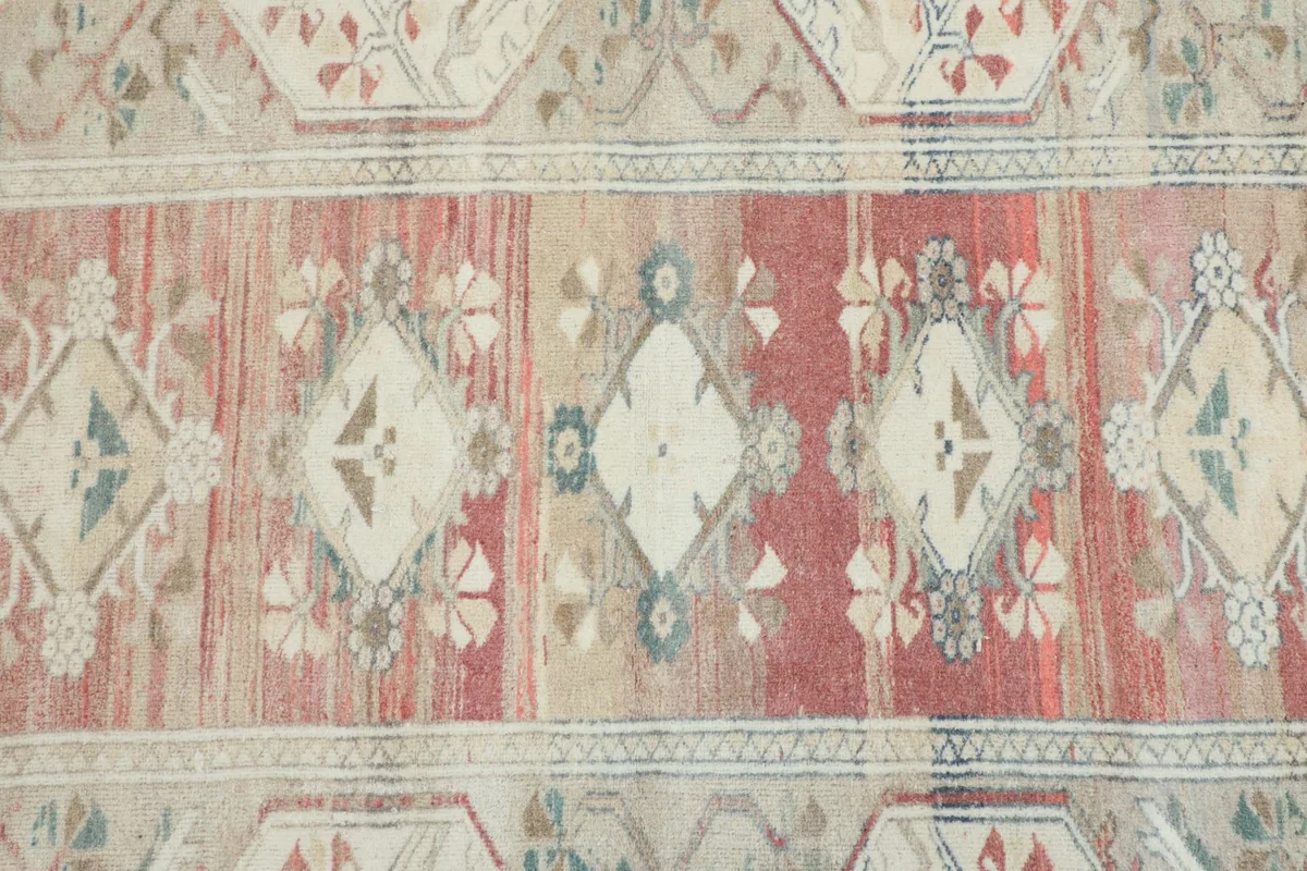 Close-up of the central rose field with geometric diamonds and floral motifs