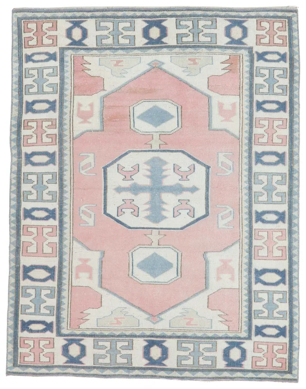 Full top view of the 4x5 vintage pink, blue, and ivory Anatolian area rug