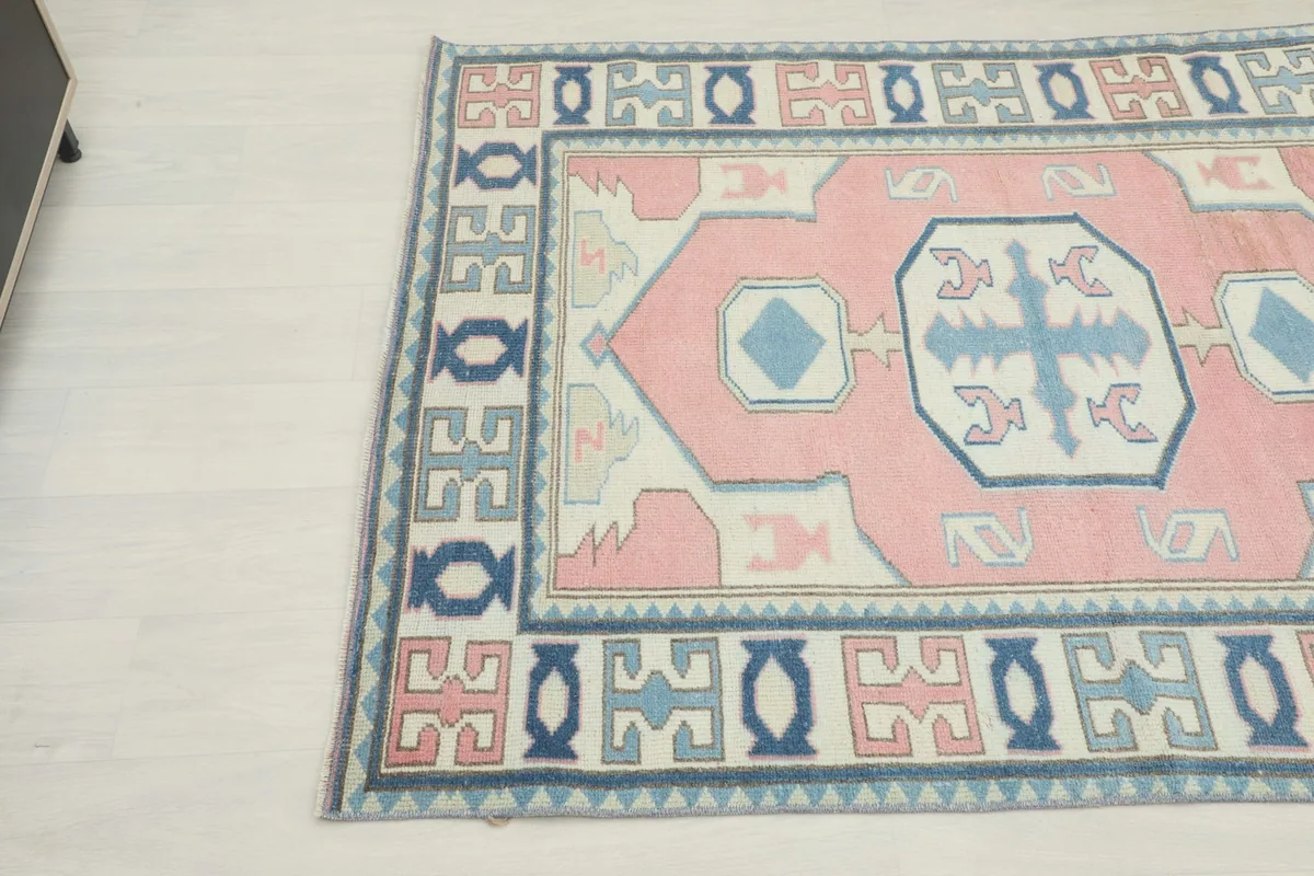 Detailed angle view highlighting the colors and patterns of the vintage area rug
