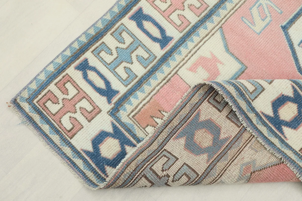 View showing the low wool pile and the intricate border design of the rug