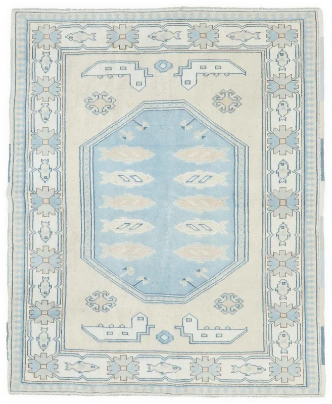 Full top view of the 5x6 ivory and blue vintage Anatolian rug with fish and geometric patterns