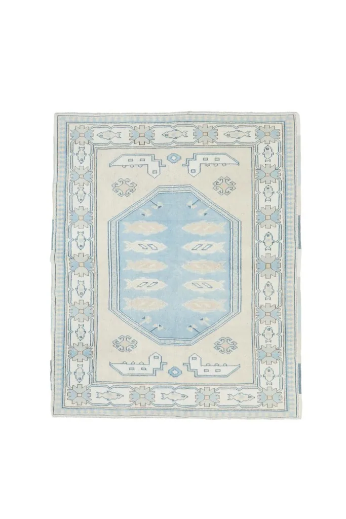 Full overhead view of the vintage Anatolian rug on a white background, showcasing its complete design