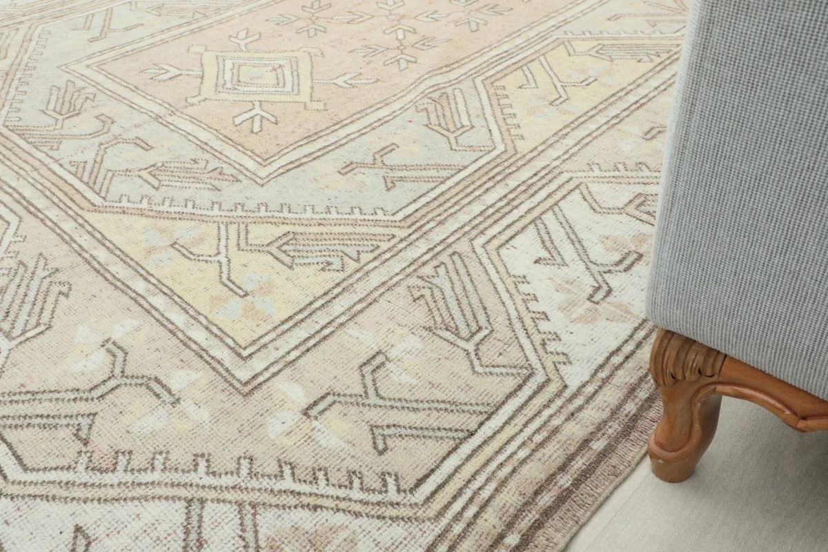 Partial view of the rug next to a chair leg, showing how it complements home furnishings.