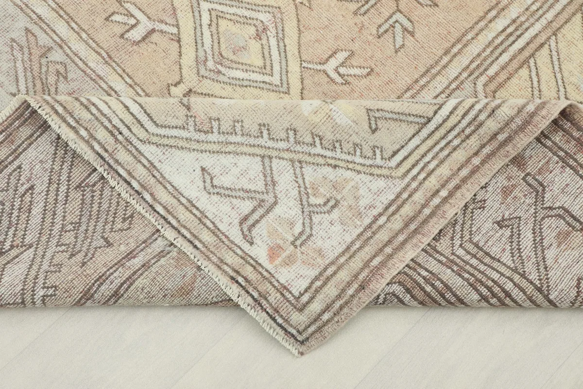 Folded corner of the rug, illustrating the flexibility and construction of the hand-knotted wool.