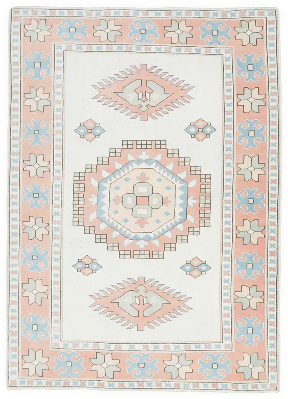 Full top view of the 6'8" x 9'6" vintage Anatolian rug with cream, rose, and blue geometric patterns.