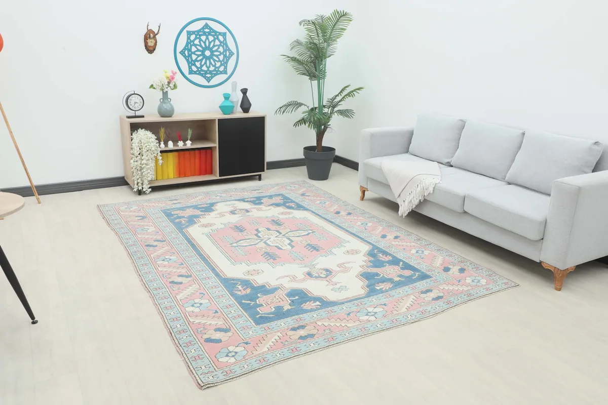 Vintage Anatolian rug displayed in a living room setting with a sofa and side table