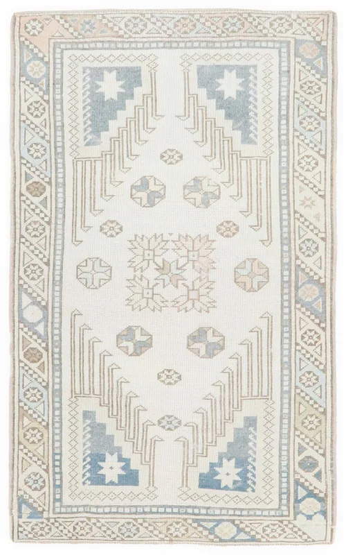 Full overhead view of the 3x5 ivory and blue geometric Anatolian rug