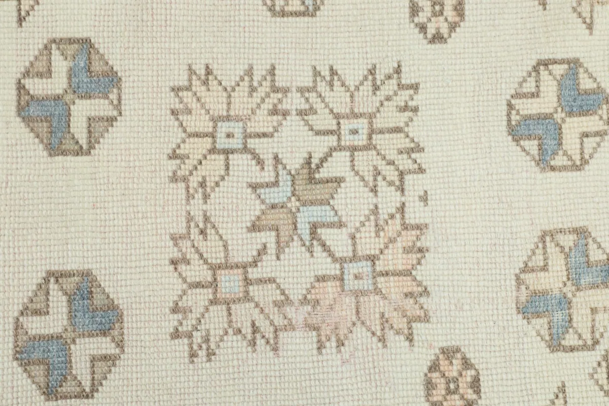 Macro detail of the hand-knotted wool pile and intricate central motif of the rug