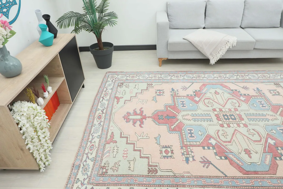 Area rug in a room, showing its scale next to a wooden console and a sofa, from an angle.