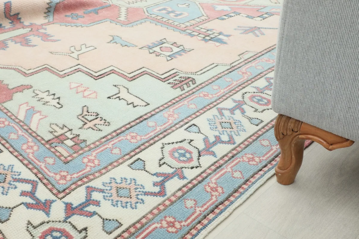 Rug placed in a room, with a sofa leg visible, illustrating its fit into a home decor scheme.