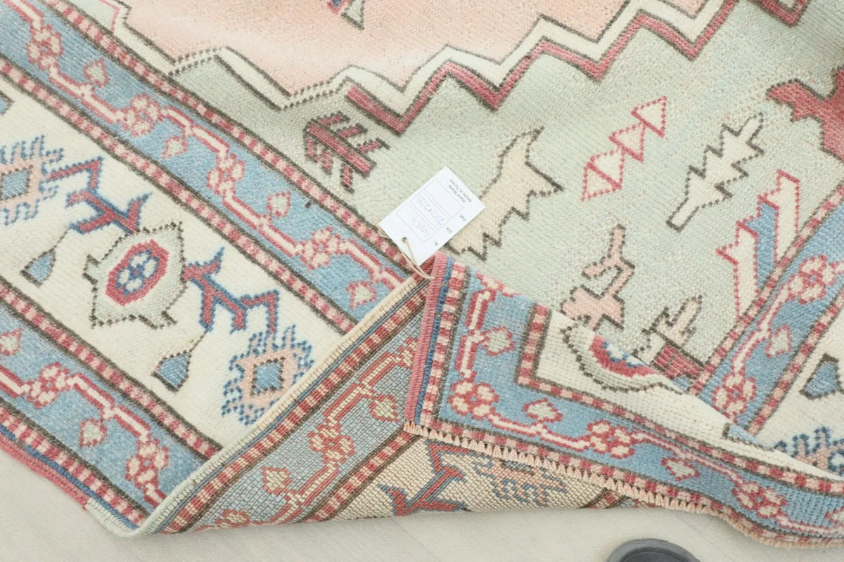 View of the back of the rug, showing the hand-knotted construction and foundation.