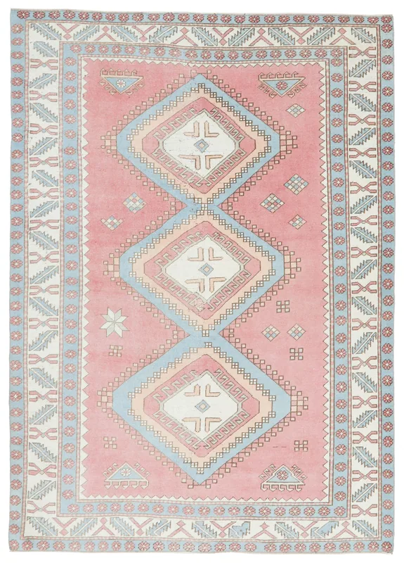 Full overhead view of the vintage rose tribal diamond Anatolian rug on a white background