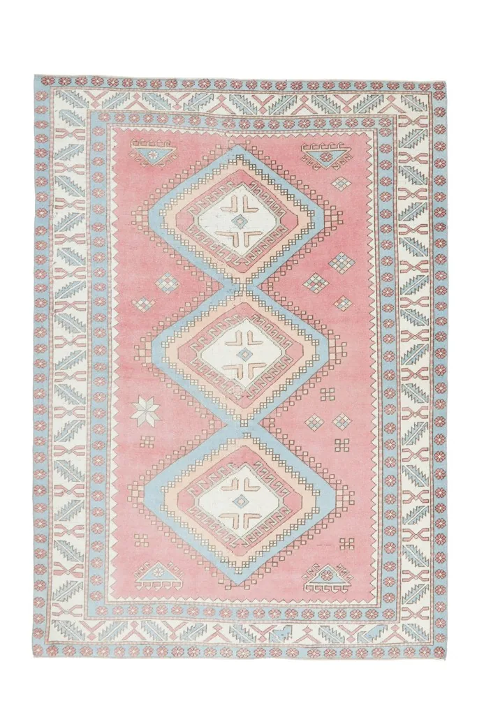 Full overhead view of the vintage rose tribal diamond rug, showing its complete design and colors