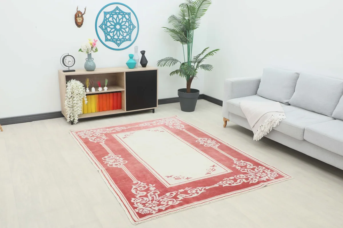Vintage rose and ivory rug displayed in a modern living room setting