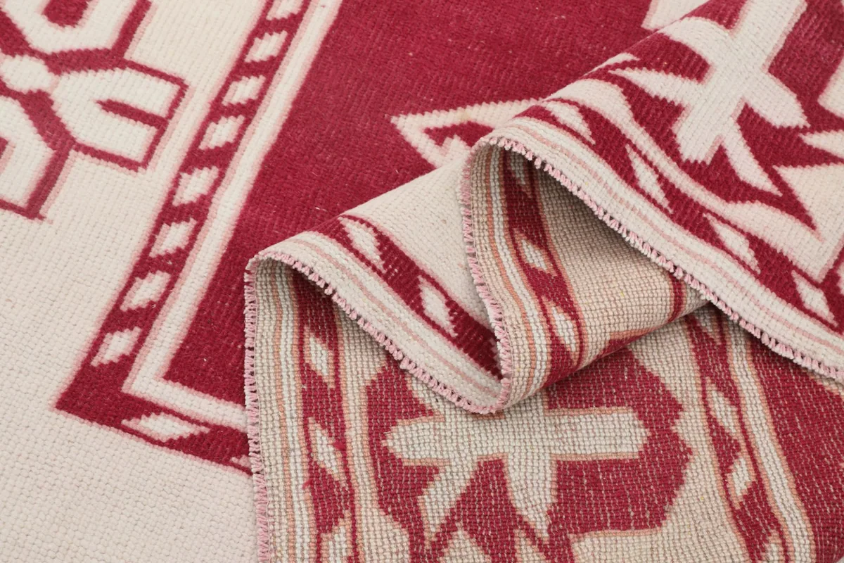 Another folded view of the rug, showing the reverse side and the hand-knotted construction.