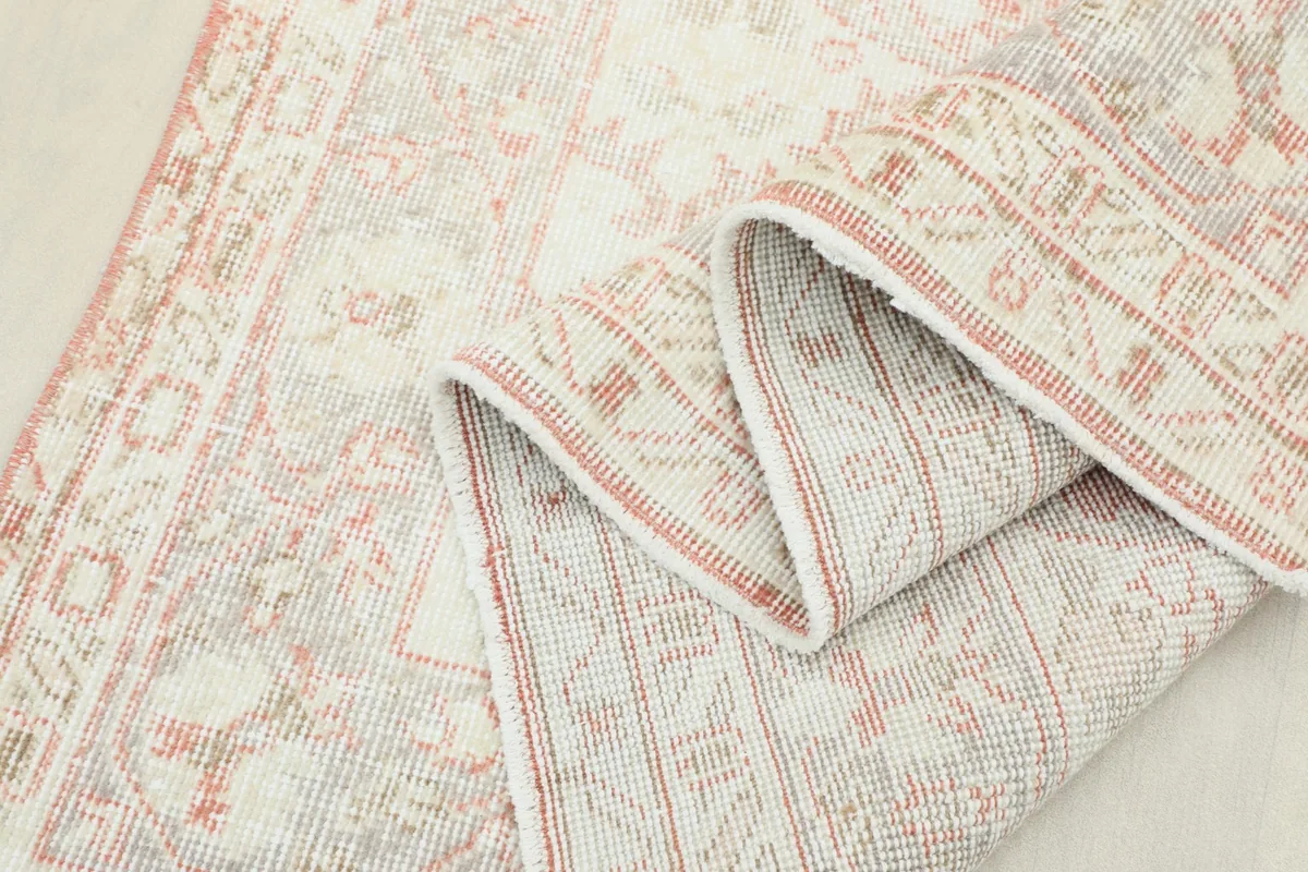 Close-up of the rug's fold, demonstrating the flexibility and texture of the hand-knotted wool.
