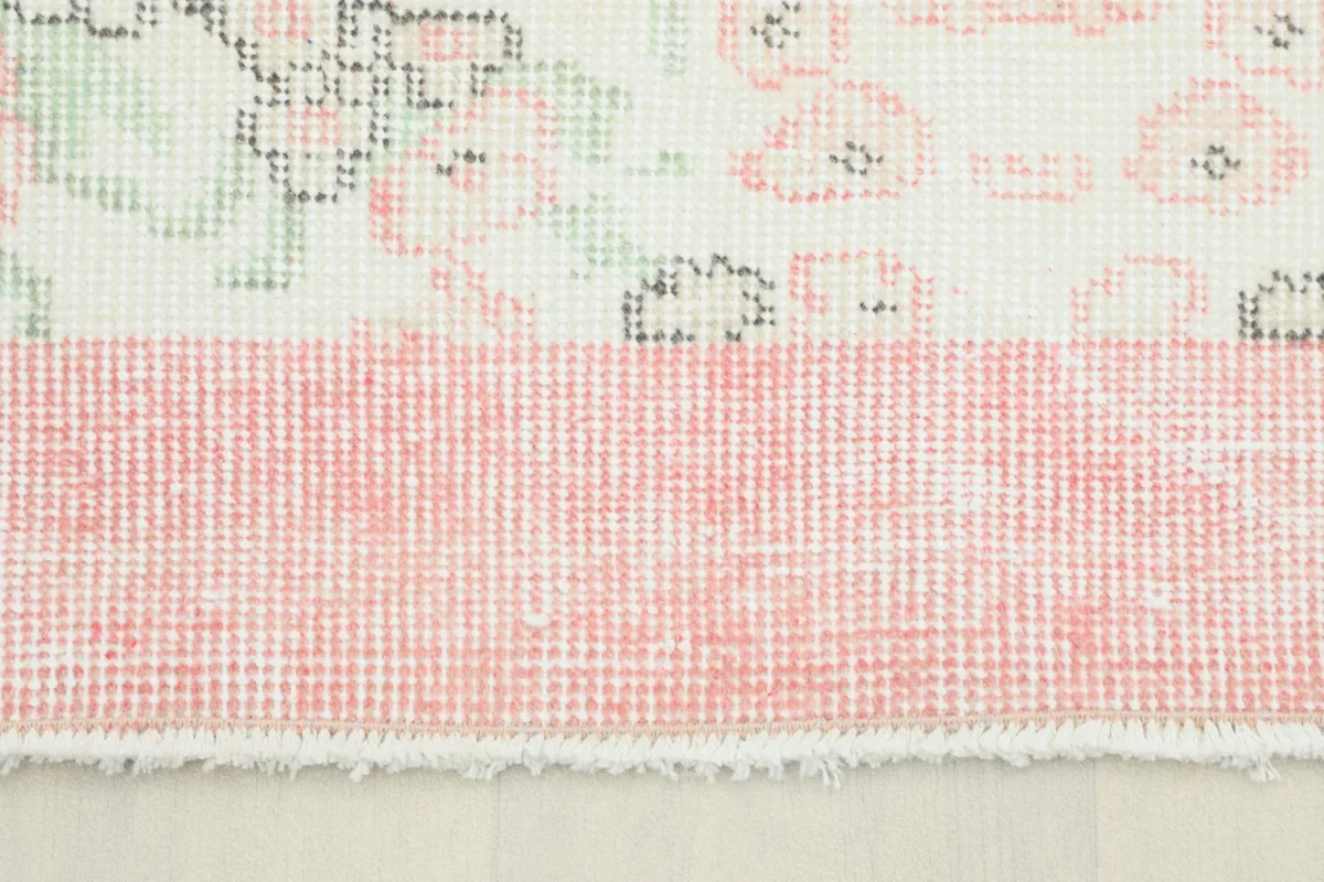 Close-up view of the pink border and the cream field with subtle floral patterns