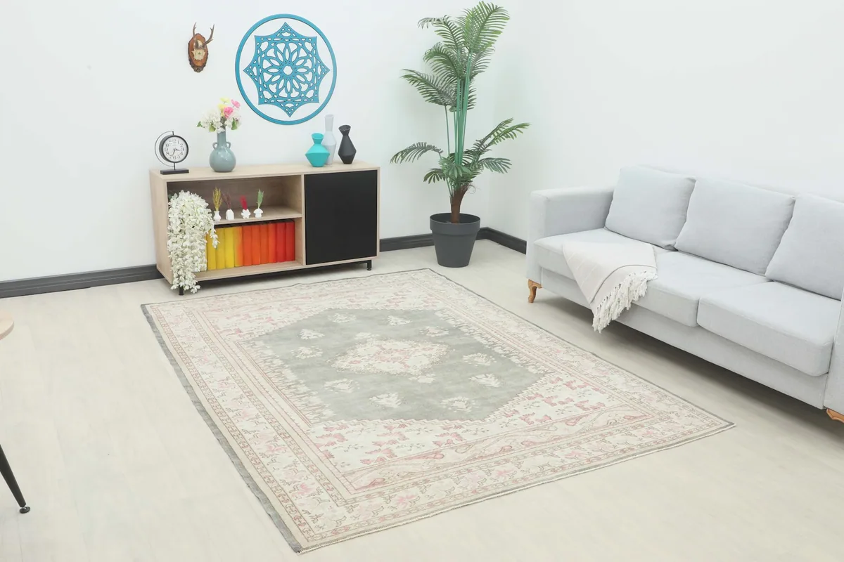 Vintage Anatolian rug displayed in a bright room setting with modern furniture.