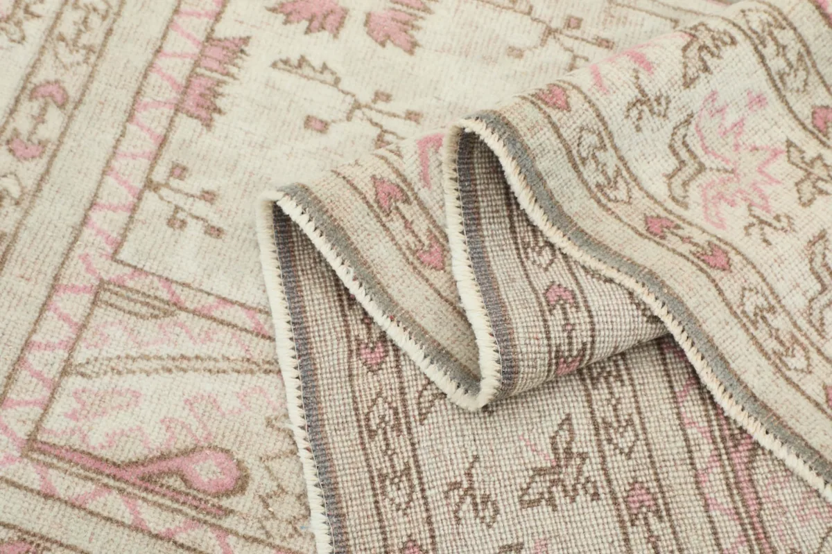Close-up of a folded section of the rug, showing the texture and detail of the patterns.